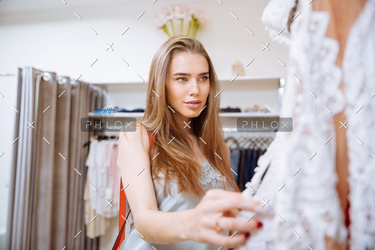 demo-attachment-141-woman-doing-shopping-and-choosing-clothes-in-PDEP6XU